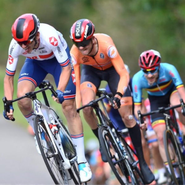 Will Bjergfelt Para Cyclist competing on road with two riders behind